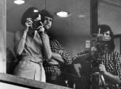 Mrs. Andrea Deratany takes pictures of her husband from the balcony - Tallahassee, Florida.