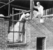 Boys laying brick in the construction of a building at the Florida Industrial School for Boys in Marianna, Florida.