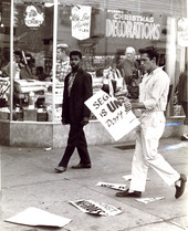 White youth ripping poster during demonstration at McCrory's in Tallahassee.