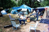 Jack Piccalo plays his banjo in the camping area - White Springs, Florida .