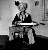 Arnold "Red" Brim with his "lap-steel" or "biscuit board" slide guitar- Live Oak, Florida
