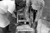Rufus Adams and step-daughter Annie Sellers using corn husk to make a chair bottom- Mayo, Florida