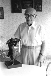 Jacob Sheiniuk standing with one of his sculptures of Klezmer musicians - North Miami Beach, Florida