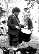 Drummer from a pipe band practicing at a Scottish Games event