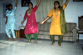 Nila Radhakrishnan (in red) teaching apprentices Prema Menon (L) and Priya Menon East Indian dance- Dade City, Florida