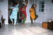 Nila Radhakrishnan (in red) teaching apprentices Prema Menon (L) and Priya Menon East Indian dance- Dade City, Florida