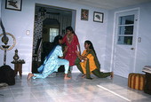 Nila Radhakrishnan (in red) teaching apprentices Prema Menon (L) and Priya Menon East Indian dance- Dade City, Florida