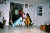 Nila Radhakrishnan (in red) teaching apprentices Prema Menon (L) and Priya Menon East Indian dance- Dade City, Florida