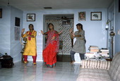 Nila Radhakrishnan (in red) teaching apprentices Prema Menon (L) and Priya Menon East Indian dance- Dade City, Florida