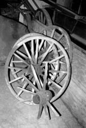 Wagon wheels being worked on by wheelwright John Luther- McAlpin, Florida