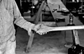 Glen Simmons holding a piece of wood that is part of his Everglades skiff- Florida City, Florida.