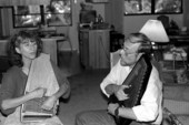 Autoharp player Charley Groth teaching apprentice Cheryl Belanger how to play the instrument- Crystal Beach, Florida