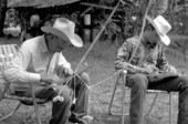 Cow whip maker George "Junior" Mills (l) and his apprentice J. Taylor Marcus working - Okeechobee, Florida.