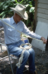 Cow whip maker George "Junior" Mills working on whip - Okeechobee, Florida.