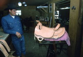 Gregory Gaughan, apprentice to saddlemaker Mike Wilder, with unfinished saddle - Kenansville, Florida