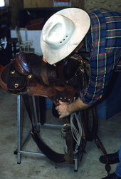 Saddlemaker Mike Wilder inspecting a saddle - Kenansville, Florida
