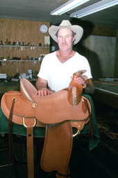 Saddlemaker Mike Wilder in workshop with saddle - Kenansville, Florida