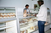 Customer at the sales area of the Jamroc Bakery buying Jamaican baked goods - Belle Glade, Florida.
