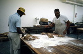 Jamroc Bakery employees slicing bread dough mixture - Belle Glade, Florida.