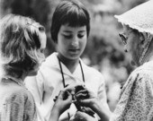 Jessie Coker showing spun thread to girls at the 1959 Florida Folk Festival - White Springs, Florida