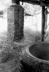 Kettle and chimney used in making cane syrup - White Springs, Florida.