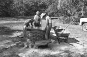 Installing kettle in cane furnace at the Stephen Foster State Folk Culture Center - White Springs, Florida.