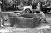 Installing kettle in cane furnace at the Stephen Foster State Folk Culture Center - White Springs, Florida.