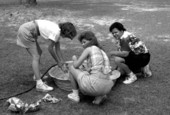 Debbie Fant, left, Mary Ann Tomlinson, and Yvonne Bryant filling wading pool at Fourth of July celebration - White Springs, Florida