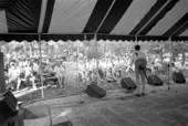 Storyteller and musician Gamble Rogers speaking to audience from the old marble stage at the 1987 Florida Folk Festival - White Springs, Florida