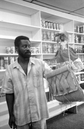 Man looking at crafts in Les Cousins, a shop in Little Haiti - Miami, Florida.