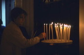 Lighting candles at St. Nicholas Cathedral during Epiphany Day services - Tarpon Springs, Florida