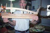 Johnny Singleton showing a side view of the model boat that he is building - Mayport, Florida.