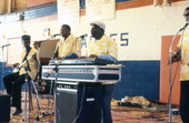 Key West Island Junkanoos performing for middle high school audience - Bronson, Florida.