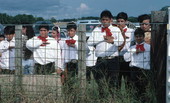 Male Dancers peer through a fence - Pierson, Florida