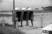 Phone booth users at the beach.