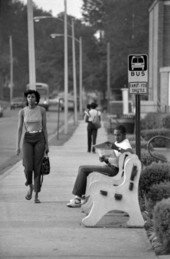 Man and woman near a bus stop - Tallahassee, Florida.