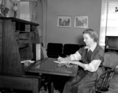 Mrs. Morneweck writing at her desk