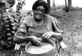Portrait of Ella Mae Huffman with her pine needle basket in Gainesville, Florida.