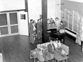 View showing servicemen gathered around piano at the Gainesville Recreation Department's Service Center.