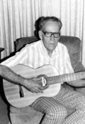 Portrait of guitar maker Emilio Castellanos with one of his guitars in Miami, Florida.