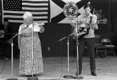Storyteller Thelma Boltin and folk musician Gamble Rogers on stage at the 1982 Florida Folk Festival.