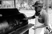 Man from the Community Revival Center cooking food at the 1983 Florida Folk Festival - White Springs, Florida