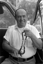 Bluegrass musician Bunch Bass with a "magic" horseshoe puzzle at the 1983 Florida Folk Festival - White Springs, Florida