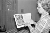 Margaret Triay pointing to crocheted item in magazine - Elkton, Florida