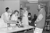 Flora Mae Hunter watching audience sampling her rice cakes at the Leon County library - Tallahassee, Florida.