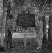 Park ranger and visitor in front of historical marker at Tomoka State Park - Ormond Beach, Florida