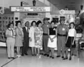 Staff and volunteers in front of the Florida DNR exhibit for Wildlife Week at an unidentified shopping mall