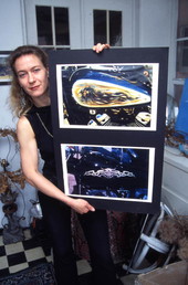 Artist Gudrun Weller showing pictures of some of her work - Daytona Beach, Florida.
