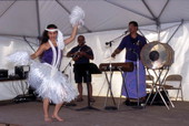 Kaleinani Ohumukini dances while Henry Ohumukini and James Buchin plays at Florida Folklife Festival - White Springs, Florida.