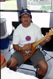 Unidentified man playing a Tahitian banjo - Celebration, Florida.
